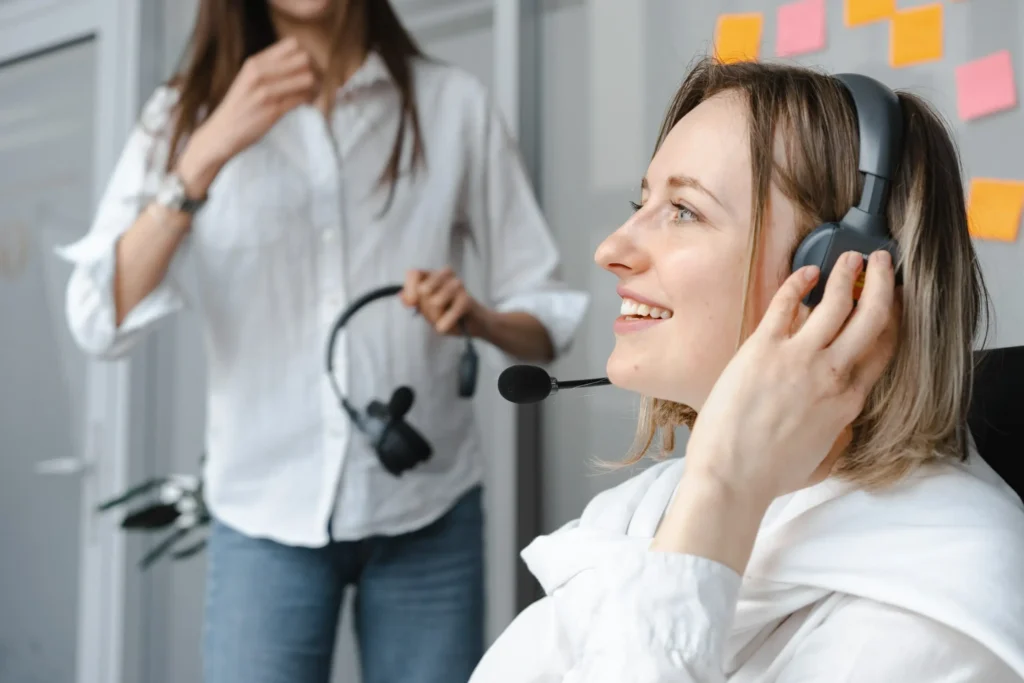 Customer support agent wearing headset during a professional office conversation