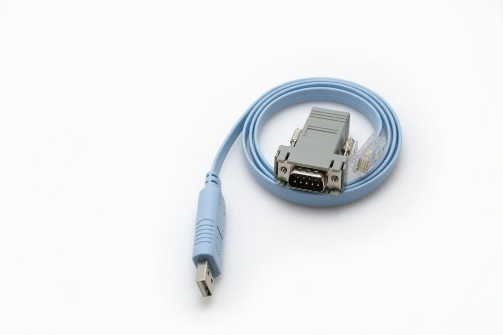 Light blue USB to serial adapter cable coiled neatly